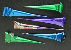 four different colored toothbrushes sitting next to each other on top of a table