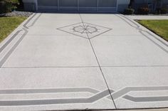 a concrete driveway with an intricate design painted on it