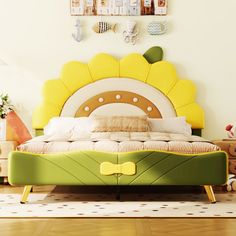 a child's bedroom with a yellow flower headboard on the bed and toys