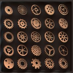 an assortment of gears and wheels are shown in a shadow box on a black surface