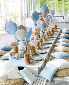 a table set up with teddy bears and balloons