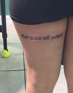 a person with a tattoo on their leg that says, what is real wallpaper?