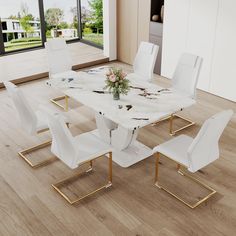 a dining table with white chairs and flowers on it