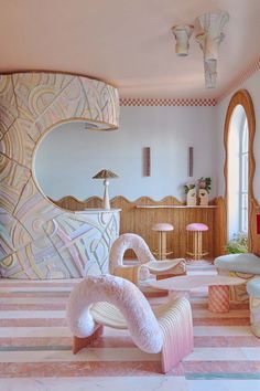 an artisticly designed living room with pink and white furniture