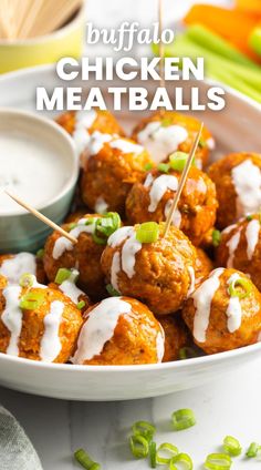 buffalo chicken meatballs in a white bowl with green onions and ranch dressing on the side