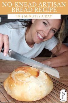 a woman holding a knife over a loaf of bread