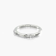 a white gold ring with three diamonds