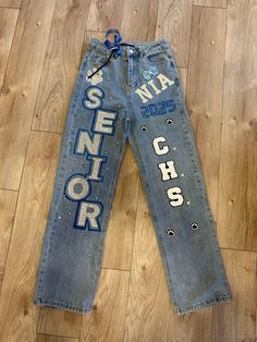 Black girl senior jeans  Blue school Senior Sunrise Pants Ideas, Pink And White Senior Jeans, Black And Gold Senior Jeans, Senior Jeans Patches, Painted Jeans Diy School Spirit, Homecoming Jeans Ideas Juniors, Senior Jeans Inspo 2025, Senior Diy Pants