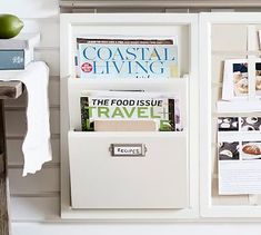 there is a magazine rack with magazines on the wall next to a shelf filled with books