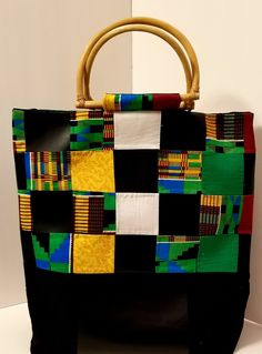 "Kente Cloth Bag | 100% Cotton and Vinyl Bag | Oversized Handbag | Boho Bag | Handcrafted Block Bag | Weekend Bag | Handmade | Gift When boho, traditional African fabric and vinyl meet, the combination is magical. These two textures have created this oversized handbag that is durable, reusable, and eye-catching. Along with the \"D-Shape\" handles and large inner pocket the bag is perfect for any occasion. Excited to introduce you all to my new \"Oversize Bag Collection. Handmade in a SMOKE-FREE Multicolor Top Handle Bucket Bag For Daily Use, Multicolor Top Handle Bucket Bag, Rectangular Hobo Bag With Leather Handles, Eco-friendly Green Top Handle Shoulder Bag, Eco-friendly Bag With Leather Top Handle, Eco-friendly Top Handle Bag With Leather Handles, Multicolor Top Handle Bucket Bag For Everyday, Multicolor Top Handle Bag For Daily Use, Eco-friendly Leather Top Handle Bag