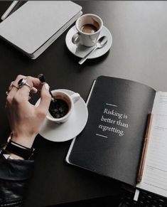 a person sitting at a table with a book and cup of coffee in front of them