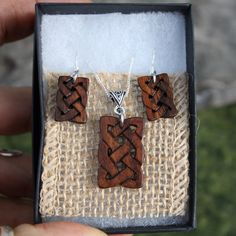 "This beautiful and unique hand-carved wooden Celtic knot jewelry set will be made for you, or a loved one, in my studio on the West of Ireland. These dainty rosewood Celtic necklace & earrings are recycled from musical instruments constructed by a local luthier. As a musician myself, I take enormous satisfaction in creating a jewelry set whose inherent wood has previously featured in a beautiful hand-made guitar. Also, part of rosewood's attractiveness is its durability and ability to stand Traditional Natural Jewelry As A Gift, Traditional Natural Jewelry For Gifts, Handmade Wooden Pendant Jewelry, Handmade Mahogany Jewelry For Gift, Handmade Mahogany Jewelry Gift, Mahogany Handmade Jewelry For Gift, Handmade Artisan Mahogany Jewelry, Unique Mahogany Jewelry For Gift, Artisan Handmade Mahogany Jewelry