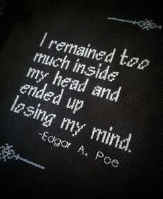 an embroidered book with the words i remains too much inside my head and ended up using my mind edgar a poe