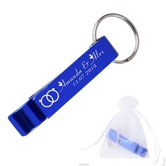 a blue keychain with a ring on it and a bag in the background