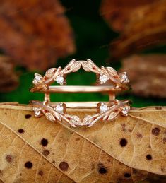 a close up of a ring on top of a leaf