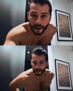 a man with no shirt on taking a selfie in front of a mirror and looking at the camera