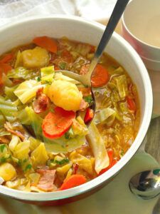 a white bowl filled with soup and vegetables