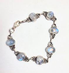 A sterling silver Labradorite vintage 1990s bracelet. With 7 oval cabochon labradorite stones of a good colour with a blue/white schiller, very similar to moonstones, each stone in it's own little settings with a single link between. Quite a robust item and weighty at 12 grams. Actual and usable length is 18 cm or just over 7", good lobster claw closure. Pretty Necklaces, Labradorite Stone, Oval Cabochon, Moon Stone, Chain Link Bracelet, Chain Link, Sterling Silver Bracelets, Labradorite, Silver Bracelet