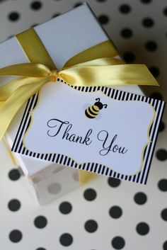 a white box with a yellow ribbon and a thank you tag on it that says, thank you