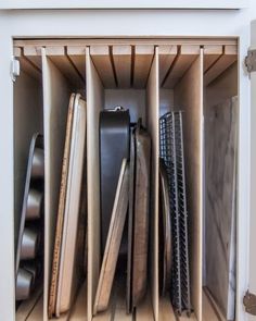 an open cabinet filled with lots of different types of knives and other things in it