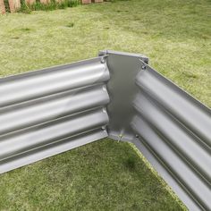 a metal gutter laying on top of green grass