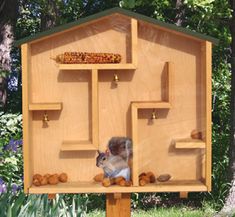 three different pictures of a wooden bird house with squirrel holes in the top and bottom