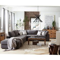 a living room filled with lots of furniture next to a tall clock mounted on the wall