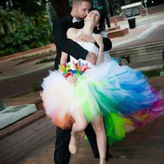 a man and woman dressed up in colorful tutus