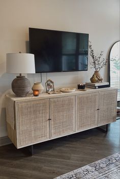 a large flat screen tv mounted to the side of a wall in a living room