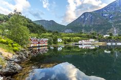 a body of water surrounded by mountains and houses