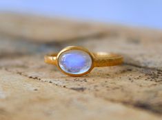 Solid Gold Natural Rainbow Moonstone  Ring - Handmade Oval Gold Ring - Textured gold ring 9K,10K,14k,18K,22K Stone Size  - 6X8 MM  Width - 2 mm  Thickness - 1.2 mm   Gold Colour Options -  Yellow Gold, White Gold, Rose Gold  Ready to Ship 1-2 week Available  White, Yellow, Rose Gold ( also in 9K, 10K, 14K, 18K, 22K ) Customization is available, I also can make it with 9k,10k,14k,18k,22k solid gold (white or rose), and diamond accent stone, just feel free to contact me. Any questions, just let me Handmade 14k Gold Oval Moonstone Ring, Handmade Oval Moonstone Ring In 14k Gold, Oval Moonstone Ring In Yellow Gold, Oval Yellow Gold Moonstone Ring, Oval Gold Ring, Textured Gold Ring, Solid Gold Ring, Etsy Gold Ring, Rainbow Moonstone Ring