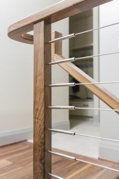 a wooden stair case with metal handrails