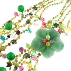 "Green Oasis Flower Gemstone 925 Sterling Silver Art Necklace Pictures cannot do justice to the rich opulence of this necklace. The centerpiece is a stunning flower cut out of solid aventurine. The necklace strap is richly beaded composition of cultured pearls and gemstones. Finished with 925 sterling. This necklace is a work of art. Pendant Size: 2 1/2\" flower Gemstone Type: Aventurine, carnelian, crystal Lock Type: Hook, 925 silver Necklace Size: 30\" Necklace Weight: ~11oz Price: 76.95" Elegant Flower Shaped Jade Jewelry, Handmade Jade Flower Necklaces, Handmade Flower-shaped Jade Necklaces, Jade Flower Necklace For Gift, Green Gemstone Flower Pendant Necklace, Green Gemstone Flower Pendant Jewelry, Green Gemstone Flower Pendant Necklaces, Green Pendant Necklace With Flower Charm, Green Multi-strand Necklace With Natural Stones