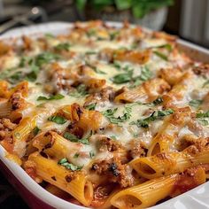 a casserole dish filled with pasta and meat