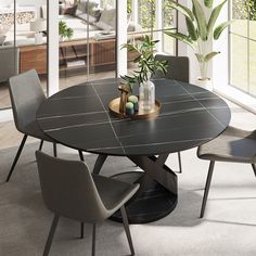 a dining table with chairs around it in front of a living room and patio area