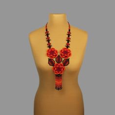 A red flower necklace is a stylish and original decoration. A boho bead necklace will make you more tender and sophisticated. A hippie bead necklace will be a wonderful birthday gift for sister. Despite the size, the seed bead necklace is not heavy.  A flower necklace is suitable for any look and is easily combined with clothes of different styles. All beaded jewelry in our assortment is unique. Each product has its own style and original design. Nevertheless, many pieces of jewelry are easily c Handmade Adjustable Red Flower Necklace, Handmade Red Flower Necklace Adjustable, Handmade Red Flower Necklace With Adjustable Fit, Red Adjustable Flower Necklace, Adjustable Red Flower Necklace, Red And Black Beaded Necklace For Festivals, Bohemian Red Necklace With Black Beads, Handmade Red Bohemian Beaded Necklace, Handmade Black Flower Necklace