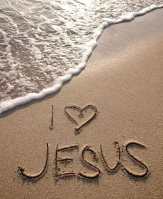 i love jesus written in the sand at the beach