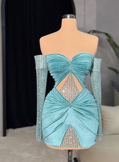 a dress made out of fabric and beads on a mannequin