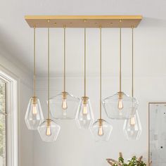 an image of a kitchen light fixture with five lights hanging from it's ceiling