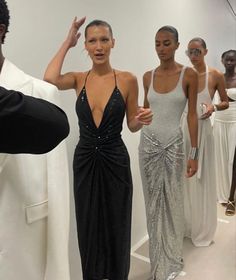 the models are all dressed up in black and white outfits, while one woman is taking a selfie