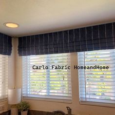 a kitchen with two windows covered in blinds and the words carlo fabric home above them