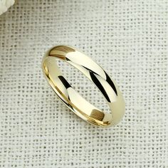 Elegant Harmony ✨💎 It gives you beautiful, attractive and outstanding jewelry experience ✨ Everlasting Confidence Wonderful Quality Stay Shiny Exquisite Fit 15,000+ customer reviews Free Shipping & Returns *Learn more 👍 Recommendations Perfect for everyday wear Ideal for travel or a destination wedding A perfect choice for an anniversary gift Description: This elegant wedding band is crafted from solid 14K gold and features a high-polished plain dome design that exudes timeless sophistication. Gold Jewelry With Shiny Finish For Wedding, Classic Polished Finish Jewelry For Weddings, Classic Formal Jewelry With Simple Design, Round Polished Wedding Jewelry, Round Polished Finish Jewelry For Wedding, Classic 14k Gold Wedding Jewelry, Gold Wedding Jewelry With Classic Design, Classic Yellow Gold Jewelry For Weddings, Classic Round Cut Wedding Jewelry