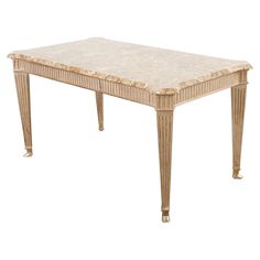 a white marble top dining table with gold trimmings on the legs and sides