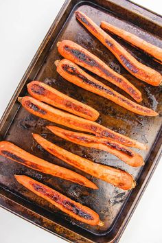 cooked carrots on a baking sheet ready to be baked in the oven for dinner