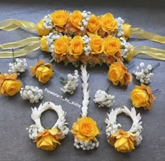 yellow roses and baby's breath are arranged on the floor