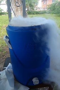 a large blue barrel with steam coming out of it