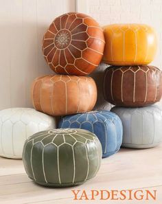 several different colored poufles stacked on top of each other