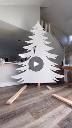 a white christmas tree cut out on the floor