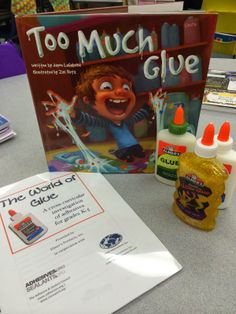 the children's book and glue are on the table