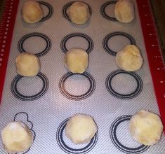 doughnuts on a baking sheet ready to go into the oven with measuring tape